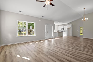 Unfurnished living room with high vaulted ceiling,