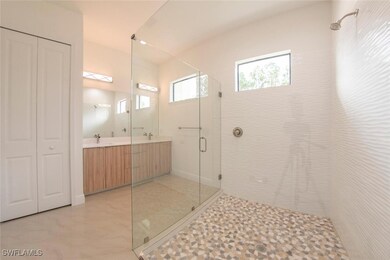 Bathroom featuring tile patterned floors, an enclo