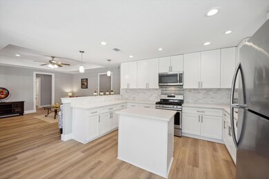 Kitchen featuring pendant lighting, appliances wit