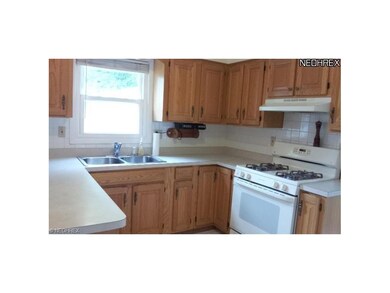 The kitchen offers plenty of cabinet storage, coun