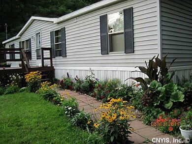 Exterior Front. Beautiful gardens blooming soon.
