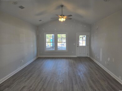 room with vaulted ceiling, ceiling fan, and dark h