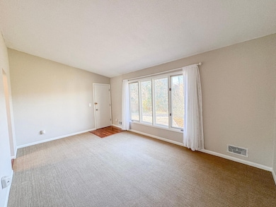 Living room with large windows and door to backyard.