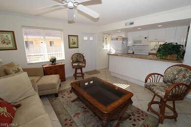 Living area featuring ornamental molding, light tile patterned floors, healthy amount of natural light, and ceiling fan