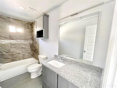 Bathroom featuring vanity and bathtub / shower combination