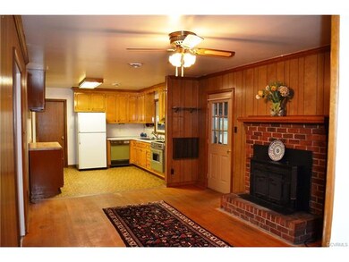 Great room den with wood fireplace connected to ma