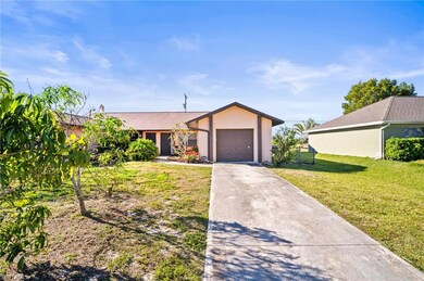 Duplex featuring driveway, a front yard, stucco si