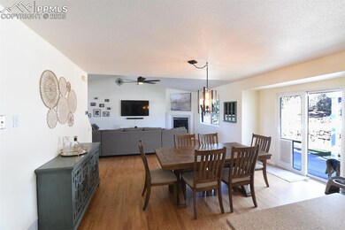 Dining area with vaulted ceiling, light wood finis