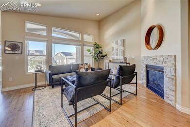 Living room with high vaulted ceiling, a stone fir