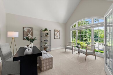 Flexible front office or great as a formal living room with soaring ceilings and a stunning arched window.