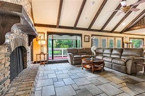 WOOD BEAMS, TILED FLOORS AND ROOM TO SIT ON THE RAISED HEARTH TO ENJOY THE WARMTH OF THE FIREPLACE.