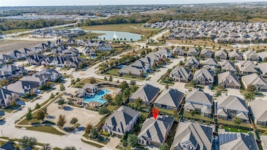 Aerial view of property and surrounding area featuring nearby suburban area and a nearby body of water