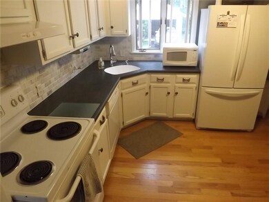 Updated kitchen with gleaming hardwoods.