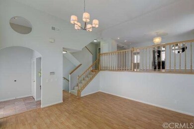 The living room features a high ceiling that gives
