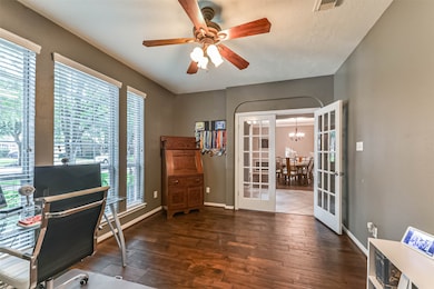 The private study offers a lush view of the front of the home. Work in peace while enjoying all the mature landscaping out front.