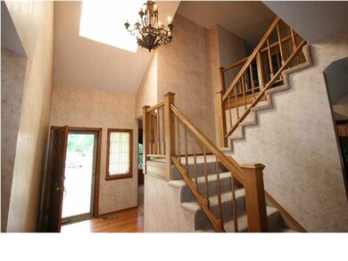Beautiful entryway with one of two staircases