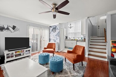Living area with ornamental molding, ceiling fan w