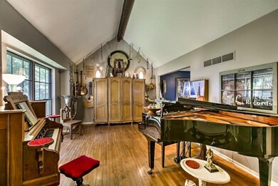 Formal living room has vaulted ceiling, gleaming h