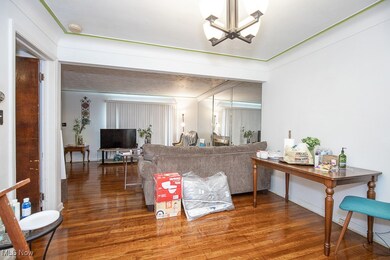 Living room with a notable chandelier and wood finished floors