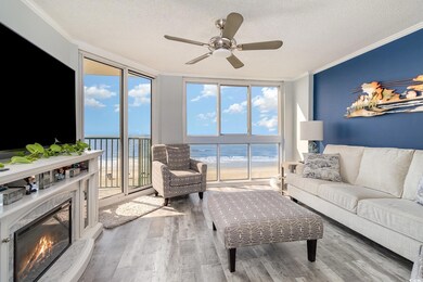 Living room featuring crown molding, a textured ce