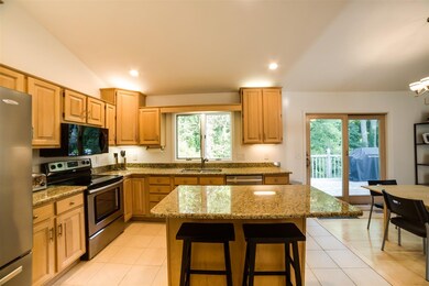 Eat in kitchen with island over hanging granite co