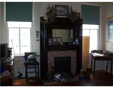 Bedroom. Another original fireplace mantel in the