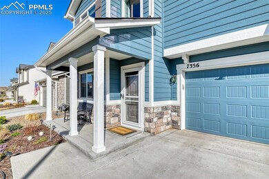 Entrance to property featuring a garage, stone sid