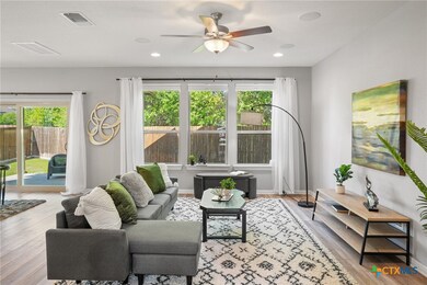 Downstairs livingroom bathed with natural light. 1