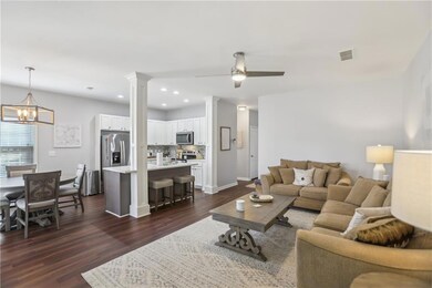 Living area with ceiling fan with notable chandeli