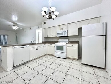 Kitchen featuring visible vents, dark countertops,