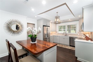 Newly update open Kitchen with stainless steel appliances and wood island with seating area.  Tray ceiling....