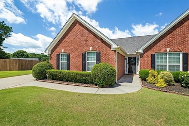 Traditional-style home featuring brick siding and a shingled roof