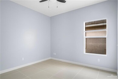Unfurnished room featuring a ceiling fan and baseboards