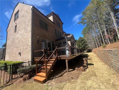 Back of property with brick siding, stairway, a wo
