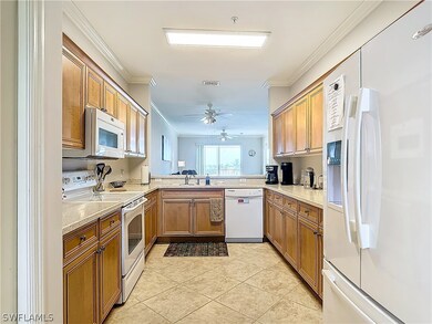 Kitchen with light tile patterned flooring, crown