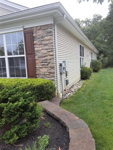 River rock along sides of house.