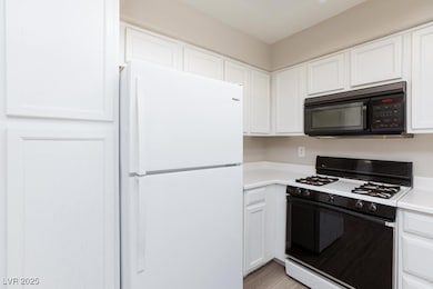 Kitchen featuring black microwave, freestanding re