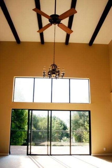 Beautiful beamed ceiling, chandelier, cooling fan,
