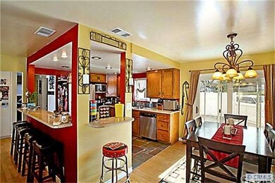 Open kitchen with breakfast bar and dining area