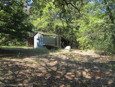 Workshop. Storage shed or workshop with a place to park on the side.