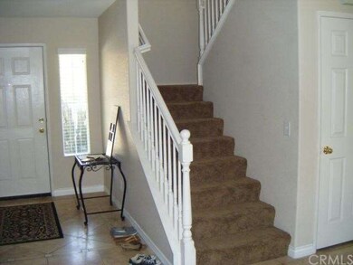 Front entry with lovely travertine tile. Stairs wi