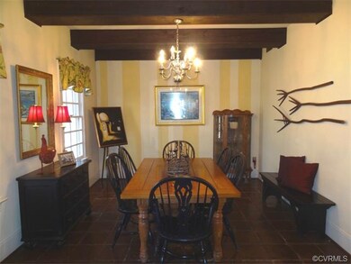Great dining room with exposed beams and mexican tile floor