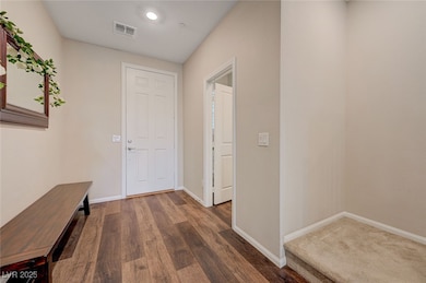 Hall featuring baseboards, wood finished floors, a