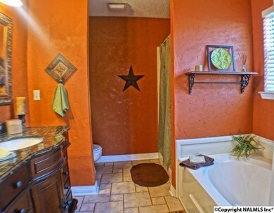 Tile floors, granite vanity , separate shower and garden tub are featured in glamour bath.