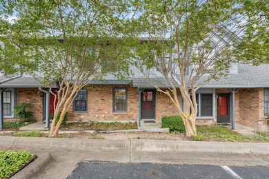 View of front of home with brick siding and a shingled roof