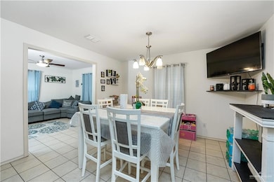 Dining space with a chandelier and light tile patterned flooring