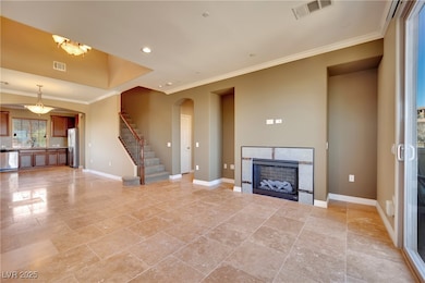 Unfurnished living room featuring visible vents, b