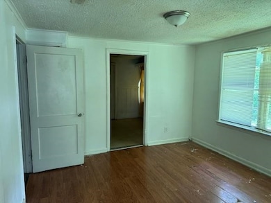 Unfurnished bedroom featuring wood finished floors