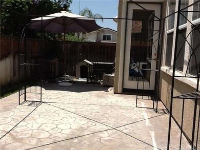 Back yard with stamped concrete.  Side door leadin
