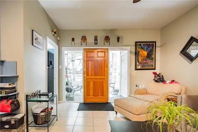 Foyer entrance featuring light tile patterned flo